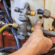 Union HVAC tech inspecting gas valve connections