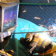 Union welder with safety helmet welding with sparks flying