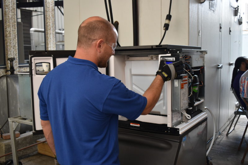 Union HVAC Technician repairs a refrigerator