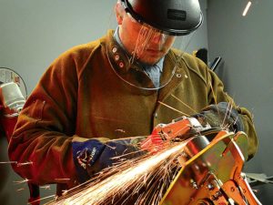 Union Pipe Trades Apprentice leans to weld